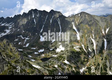 Landschaft in der Hohen Tatra mit Bergen, dem Tal Mlynicka dolina, dem See Pleso nad Skokom und dem Wasserfall Vodopad Skok. Slowakei. Stockfoto