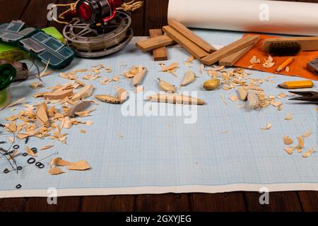 Handgemachte hölzerne Fischerei tacles graph Papier Hintergrund mit Werkzeugen und Rohlinge. Mockap für Werbung und Veröffentlichung. Stockfoto