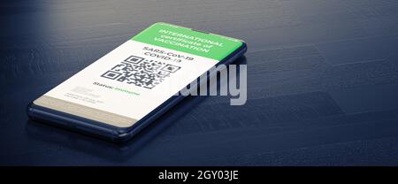 COVID-19: Digital Green Certificates auf dem Smartphone-Bildschirm. Ein Smartphone, das auf einer dunklen Oberfläche liegt, mit einem geimpften digitalen Gesundheitspass. Stockfoto