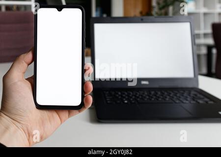 Leeres Smartphone und Laptop mit weißem Bildschirm für Mockup. Handy- und PC-Modell Stockfoto