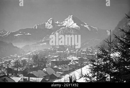 Unterwegs im Berchtesgadener Land, hier: Stadtansicht mit Blick auf die Stiftskirche und die Pfarrkirche, hinter dem Watzmannmassiv, Deutschland 1940er Jahre. Rund um Berchtesgaden, hier: Blick in die Stadt, Deutschland 1940er Jahre. Stockfoto
