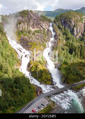 Norwegen - Låtefossen ist ein beeindruckender Zwillingswasserfall, der sich im Odda-Tal befindet. 165 Meter. Drohne vertikale Aufnahme, Tageslicht. Stockfoto