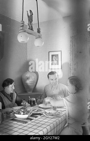 Der autorennfahrer Hermann Lang beim Essen mit seiner Familie, Deutschland 1930er Jahre. Der Rennfahrer Hermann Lang ein Mittagessen mit seiner Familie, Deutschland 1930. Stockfoto