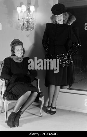 Zwei Modelle bei der Anprobe von Kleidern der Berliner Modeschöpferin Hilda Romatzki, Deutschland ca. 1939. Zwei Models versuchen Kleider der Modedesignerin Hilda Romatzki, Deutschland ca. 1939. Stockfoto