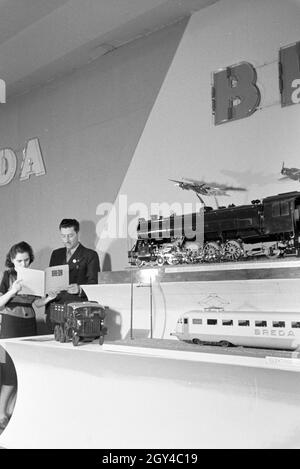 Zwei Personen vor einem Stand mit Modellen des italienischen Maschinenbau-Unternehmens Breda auf der Leipziger Frühjahrsmesse, Deutschland 1941. Zwei Personen vor einem Stand mit Modellen des italienischen Maschinenbaukonzerns Breda auf der Leipziger Frühjahrsmesse, Deutschland 1941. Stockfoto