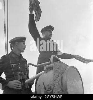 Original-Bildunterschrift: Dienst des Matrosen: Signalwinken ein Bord eines Torpedoboots, Deutschland 1940er Jahre. Flagge Semaphore auf Deck eines Torpedoboot, Deutschland 1940. Stockfoto