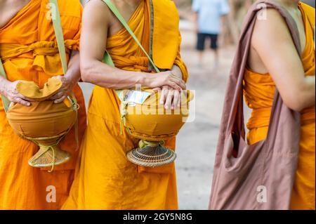 Almosen rund Um Die gelben Roben der Mönch gehen auf Almosen rund als buddhistische Aktivität. Stockfoto