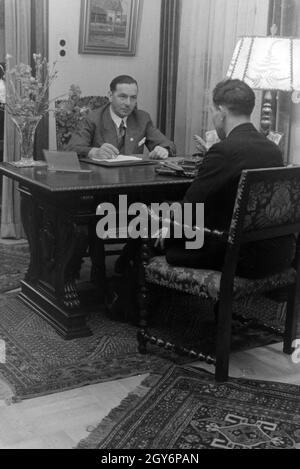 Der Inhaber des Musterbetriebs Wilhelm Pflaume mit einem Geschäftspartner, Deutsches Reich 1941. Eigentümer der Modellpflanze Wilhelm Pflaume mit einem Business Partner, Deutschland 1941. Stockfoto