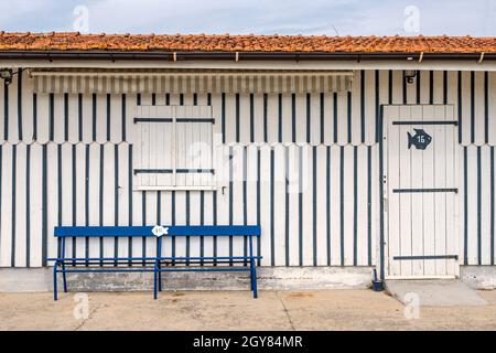 Die Hütten der Austernfischer sind alle farbenfroh mit Streifen verziert und Grenzen an den kleinen Hafen von Audenge, Bassin d'Arcachon, Frankreich Stockfoto