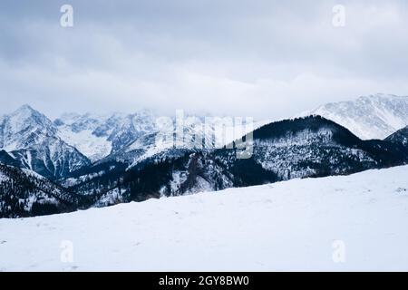 Landschaftlich reizvolle schneebedeckte Berglandschaft an einem bewölkten Tag im Winter, Tatra-Gebirge, Polen. Stockfoto