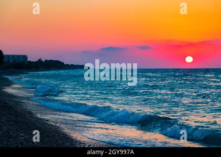 Regenbogenfarben des schönsten Sonnenuntergangs am Strand von Ialysos auf der griechischen Insel Rhodos. Stockfoto