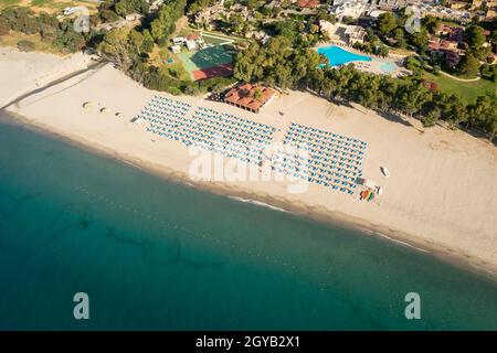 Luftaufnahme von schönem Meer und Strand mit Sonnenschirm an sonnigen Tagen, Simeri Mare, Kalabrien, Süditalien Stockfoto