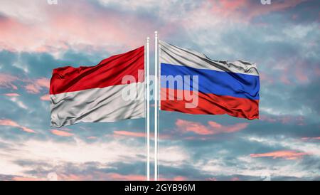 Indonesien und Russland zwei Flaggen auf Fahnenmasten und blau bewölkt Himmel Stockfoto