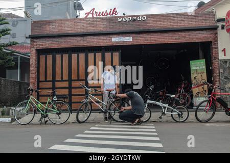 Bandung, Indonesien. Oktober 2021. Arusik Bikes Werkstatt in Bandung. Die Standard-Fahrrad-Innovation, die mit Strom modifiziert wird, basiert auf einem zusätzlichen Dynamo am Rad mit einem „Pedal Assist“- und „Gas-Gaspedal“-System, das bis zu 70 Kilometer hält. Die Custom-Akku-Power 'Arusik Bike' reicht von 250 bis 300 Watt bei einer Akkuladezeit von 4 Stunden von Null bis voll. Kredit: SOPA Images Limited/Alamy Live Nachrichten Stockfoto