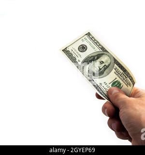 Ein 100-Dollar-Schein in der Hand auf weißem Hintergrund. Isoliert. Einhundert amerikanische Dollar Rechnung. Eine Rechnung ist Dollar. Die Hand streut die Puppe aus Stockfoto