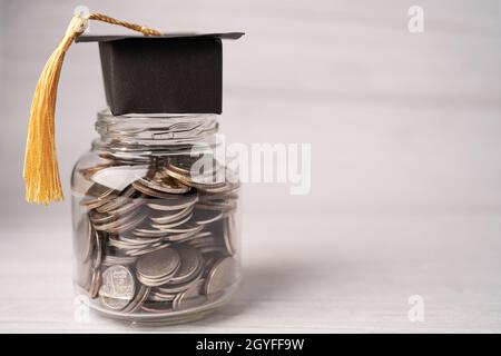 Graduierung Lücke Hut auf Münzen Geld in jar für Bildungsfonds; Studium Lernkonzept. Stockfoto