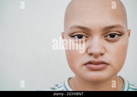 Glatze Mädchen posiert vor der Kamera im Freien - Fokus auf Augen Stockfoto