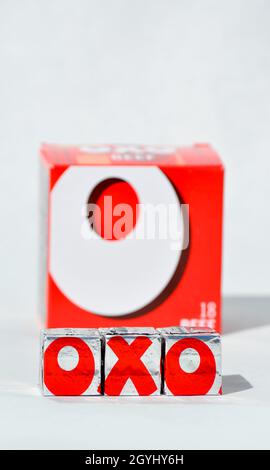 OXO-Würfel sollen OXO mit der Verpackung dahinter buchstabieren. Auf weißem Hintergrund Stockfoto