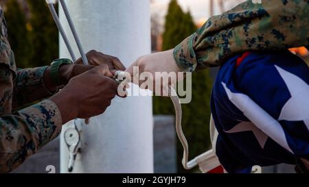 US-Marineinfanteristen mit Hauptquartier und Dienstbataillon, Henderson Hall, Hauptquartier Marine Corps, heben das nationale Fähnchen zu Ehren von General Paul X. Kelley, dem 28. Kommandanten des Marine Corps' Passing, an der Joint Base Ft. Myer-Henderson Hall, Arlington, Virginia, 5. Januar 2020. Farben können auf Anordnung des Präsidenten nach dem Tod von Hauptfiguren der Regierung der Vereinigten Staaten und des Gouverneurs eines Staates, Territoriums oder Besitzes als Zeichen ihres Gedächtnisses geflogen werden. (USA Marine Corps Foto von Lance CPL. Morgan L. R. Burgess) Stockfoto