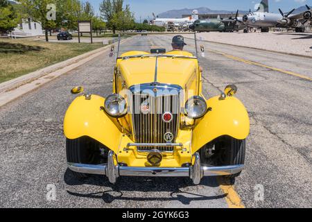 Ein restaurierter 1952 MG TD Midget Sportwagen, der an Flugzeugen vorbeifährt und im Hill Aerospace Museum in Utah ausgestellt wird. Stockfoto