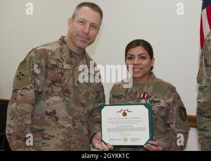 Brig. General Howard Geck, stellvertretender Generalkommandant, Operational Command Post, 1st Theatre Sustainment Command (TSC), posiert mit LT. Col. Maria Carillo, 320. Quartermaster-Abteilung, nachdem er ihr während einer Abschlussfeier der Tournee im Camp Arifjan, Kuwait, am 21. Januar 2020 eine Verdienstmedaille überreicht hatte. Das 320. QM-DET, das als Subarea Petroleum Office im Support Operations, 1st TSC OCP, diente, wird Anfang Februar neu eingesetzt. (USA Armeefoto von Meister Sgt. Jonathan Wiley) Stockfoto