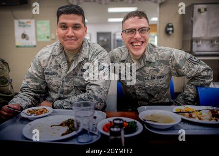 Senior Airman David Regalado und Tech. Sgt. Trenton Wollberg, 110. Wing Services Flight, Force Support Squadron, Battle Creek Air National Guard Base, mich., genießen Sie am 1. Februar 2020 eine gemeinsame Mahlzeit im Base Dining Facility. (USA Foto der Air National Guard von Gary Leonard, Senior Airman, veröffentlicht) Stockfoto