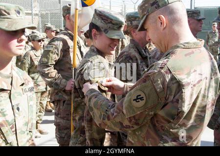 Brig. General Howard Geck, kommandierender General, 103. Expeditionary Sustainment Command (ESC), stellt Sgt. Brittany Rockwell, 103. ESC, mit einem Kampfpatch während einer Preisverleihung, Patching und Promotion-Zeremonie im Camp Arifjan, Kuwait, 2. Februar 2020. (USA Army Reserve Foto von SPC. Dakota Vanidestine) Stockfoto