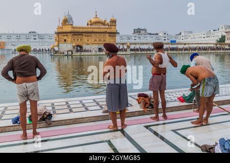 AMRITSAR, INDIEN - 26. JANUAR 2017: Sikh-Anhänger baden in einem Pool im Goldenen Tempel Harmandir Sahib in Amritsar, Punjab, Indien Stockfoto