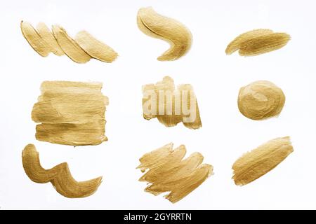 Sammlung von goldenen Pinselstrichen isoliert auf weißem Hintergrund. Stockfoto
