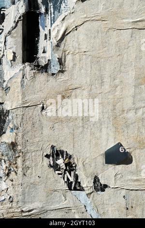 Abgenutzte abblätternde Poster auf alten verwitterten Pinnwand, grungenem Hintergrund oder Textur Stockfoto