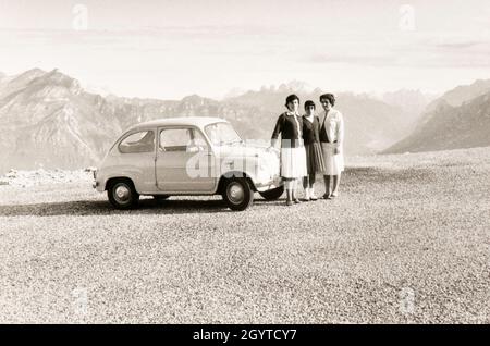 Italienische Touristen bei einer Fahrt durch die Alpenregion mit dem FIAT 600 Auto. Dieses Bild wurde Mitte der sechziger Jahre aufgenommen Stockfoto