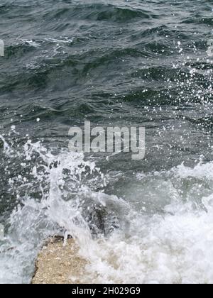 Wellen krachen über Felsen bei Anemomylos, Garitsa Bay, Korfu, Griechenland