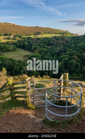 Ein küssendes Tor auf dem Weg zum Three Fingers Rock auf Caer Caradoc, mit Blick auf CWMS Farm, Hope Bowdler Hill und den Gaer Stone, Church Stretton, Stockfoto