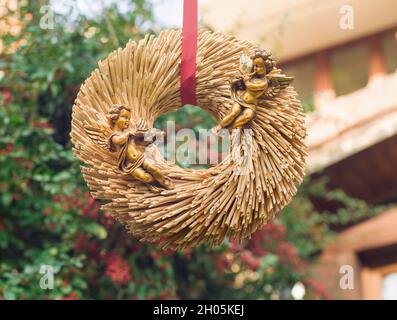 Goldene Engel auf einem Strohkranz zum Valentinstag. Stockfoto