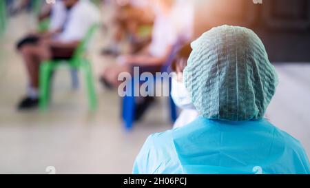Der Arzt impft Studenten in Uniform, um Coronavirus oder Covid-19 zu verhindern Stockfoto