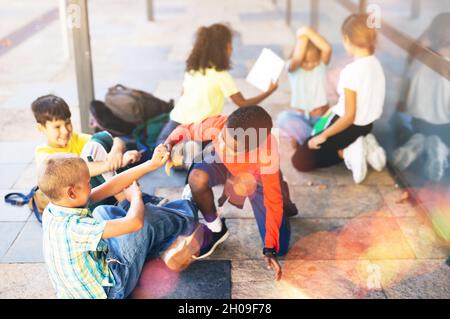 Tweenagers Schüler haben Spaß in der Nähe von Schulgebäude Stockfoto