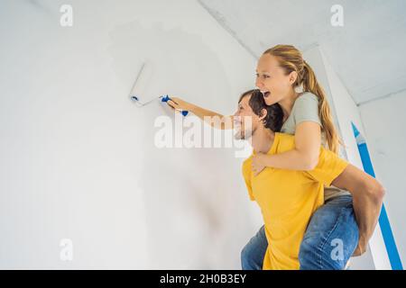 Renovierung diy Farbe Paar in neuen Hause Malerei Wand Stockfoto