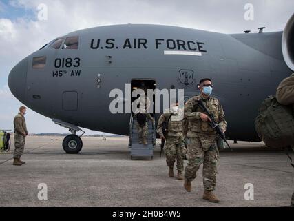 US-Soldaten mit der North Carolina Nationalgarde nehmen bei der Ankunft am 15. Januar 2021 an der Joint Base Andrews, Maryland, einen C-17 Globemaster III ab, der dem 145. Luftlift-Flügel der North Carolina Air National Guard zugewiesen wurde. Soldaten der Nationalgarde und Luftwaffe aus mehreren Bundesstaaten sind nach Washington gereist, um die Bundes- und Bezirksbehörden im Vorderen der 59. Amtseinführung des Präsidenten zu unterstützen. Stockfoto