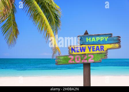 Apy Neujahr 2022 geschrieben auf Wegweisern, tropischen Strand Hintergrund, Reise-und Tourismus-Grußkarte Stockfoto
