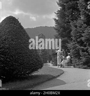 Ein Mann und zwei Frauen in einem Park in Wildbad im Schwarzwald, Deutschland 1930er Jahre. Ein Mann mit zwei Frauen in einem Park in Wildbad im Schwarzwald, Deutschland, 1930. Stockfoto