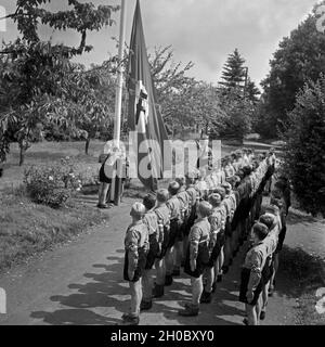 Morgendlicher Fahnenappell im Jungen Landjahr Lager in Bevensen in der Lüneburger Heide, Deutschland 1930er Jahre. Morgendliche flag Muster bei der Hitler Jugend Camp in Bevensen, Deutschland 1930. Stockfoto