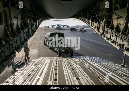 Artilleristen von B Battery, 3. Bataillon, 7. Feldartillerie, 25. Infanterie-Division Artillerie kehren ihre Humvee- und M19A3-Haubitze in eine Air Force C-17 Globemaster III um, in Vorbereitung auf die Operation Bull Wings Emergency Deployment Readiness Exercise (EDRE) auf der Hickam Air Force Base, Hawaii, 21. Januar 2021. Der EDRE ist eine Schnelleinsatzübung ohne Vorankündigung, die die Fähigkeit einer Einheit testen soll, Kräfte und Ausrüstung für Notfälle oder Notfalleinsätze zu alarmieren, zu vermarschen und einzusetzen. Stockfoto