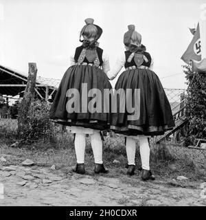 Rückansicht Zweier Mädchen in der Tracht der Westhessischen Schwalm, 1930er Jahre Deutschland. Rückansicht der beiden Mädchen tragen die westlichen hessische Array des Gebiets Schwalm, Deutschland der 1930er Jahre. Stockfoto