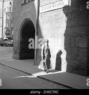 Eine ältere Dame spaziert durch die Straße in Innsbruck in Österreich, Deutschland, 1930er Jahre. Eine ältere Dame throuig schlendert durch die Straßen von Innsbruck in Österreich, Deutschland 1930. Stockfoto