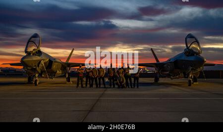 Taktische Flugzeugwarter, die dem 34. Jagdgeschwader der auf der Hill Air Force Base, Utah, zugewiesen wurden, posieren für ein Foto zwischen zwei F-35A Lightning II-Kampfflugzeugen vor einer Red Flag 21-1-Mission auf der Nellis AFB, Nevada, 8. Februar 2021. Red Flag bereitet Wartungspersonal, Bodenkontrolleure sowie Weltraum- und Cyberbetreiber darauf vor, Missionen im gleichen taktischen Umfeld wie Piloten und leitende Führungskräfte zu unterstützen. Stockfoto