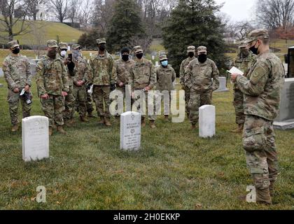 SPC der US-Armee. Rory Endsley, rechts, ein Infanterist mit Bravo Company, 2. Bataillon, 108. Infanterie-Regiment, 27. Infanterie-Brigade-Kampfteam, 42. Infanterie-Division, New York National Guard, Und Pulaski, gebürtiger New Yorker, spricht über den historischen Träger der Ehrenmedaille, Maj. General William, „Wild Bill“ Donovan, während eines hochrangigen, von Leiters vereißten Besuches auf dem Arlington National Cemetery in Arlington, VA., 14. Februar 2021. Donovan, der später als Leiter des Büros für strategische Dienste, dem Vorläufer der CIA, fungieren sollte, erhielt für seine Taten die Ehrenmedaille, während er das 165. Regiment befehlig Stockfoto