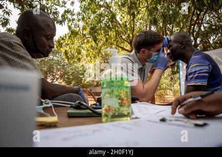 US Army Staff Sgt. Aidan McNulty, dem Civil Affairs Team (CAT) 142, Delta Co. 91. Civil Affairs Bataillon, zugewiesen, leistet medizinische Hilfe für einen Bürger von Burkina Faso in Bobo-Dioulasso, Burkina Faso, 19. Februar 2021. Angehörige des US-Militärs stellten in Bobo-Dioulasso medizinische Geräte und Schulungen für die Militärärzte von Burkinabé bereit. Die Ausbildung unterstützte die medizinischen Untersuchungen und Behandlungen von mehr als 400 Menschen mit der US-Militärhilfe, die sich auf den Aufbau der Kapazitäten der Sicherheitskräfte Burkina Fasos konzentrierte. Stockfoto