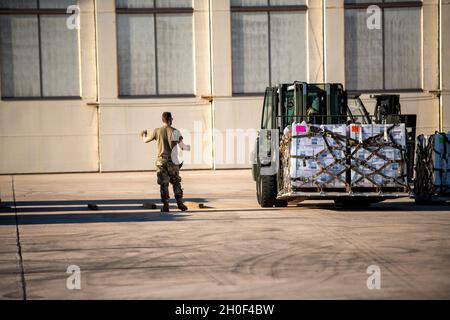 U.S. Air Force Airmen transportiert mit dem 502. Logistics Readiness Squadron Paletten mit abgefülltem Wasser, 21. Februar 2021, auf dem Joint Base San Antonio-Kelly Field, Texas. Der 502LRS unterstützte die Koordination und das Entladen von etwa 80,000 Flaschen Wasser, die über Flugzeuge auf dem Kelly Field eingeliefert wurden und nach dem Wintersturm Uri an die Stadt San Antonio verteilt wurden. Stockfoto