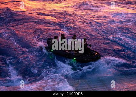 US-Marineinfanteristen mit der 31. Marine Expeditionary Unit (MEU) und Matrosen der Marine bereiten sich darauf vor, während einer Onload-Übung an Bord des Landungsschiffes USS Ashland (LSD 48) in der philippinischen See, 24. Februar 2021, ein Kampfflugzeugnis zu starten. Die 31. MEU ist an Bord der Schiffe der Amphibiengeschwader 11 im Einsatzgebiet der 7. Flotte tätig, um die Interoperabilität mit Verbündeten und Partnern zu verbessern und als einsatzbereite Einsatztruppe zur Verteidigung von Frieden und Stabilität in der Indopazifik-Region zu dienen. Stockfoto