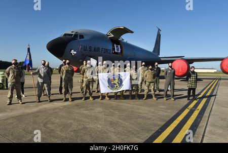 Leadership, Airmen und Zivilisten des 100th Operations Support Squadron posieren für ein Foto vor ihrem neu gesponserten KC-135 Stratotanker-Flugzeug, mit dem „Wolff Pack“, einem im Zweiten Weltkrieg erbauten Nasenkunstwerk, bei der Royal Air Force Mildenhall, England, am 26. Februar 2021. Im Rahmen eines neuen „Adopt-a-Jet“-Programms werden die Geschwader der RAF Mildenhall einen Jet mit einer besonderen Tradition der Nasenkunst sponsern, um die Geschichte der 100. Bombardierungsgruppe wieder in den Hintergrund zu rücken. Stockfoto